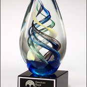 1610 -   Egg-shaped art glass award on black glass base 2-3/4 " x  7-1/8 "